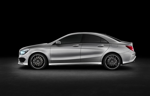 Side view of the 2014 CLA250 with the AMG styling package and upgraded wheels. The flowing lines eliminate the feeling of slab sides common in many cars.  The roof is steeply raked to give the coupe-like effect. 